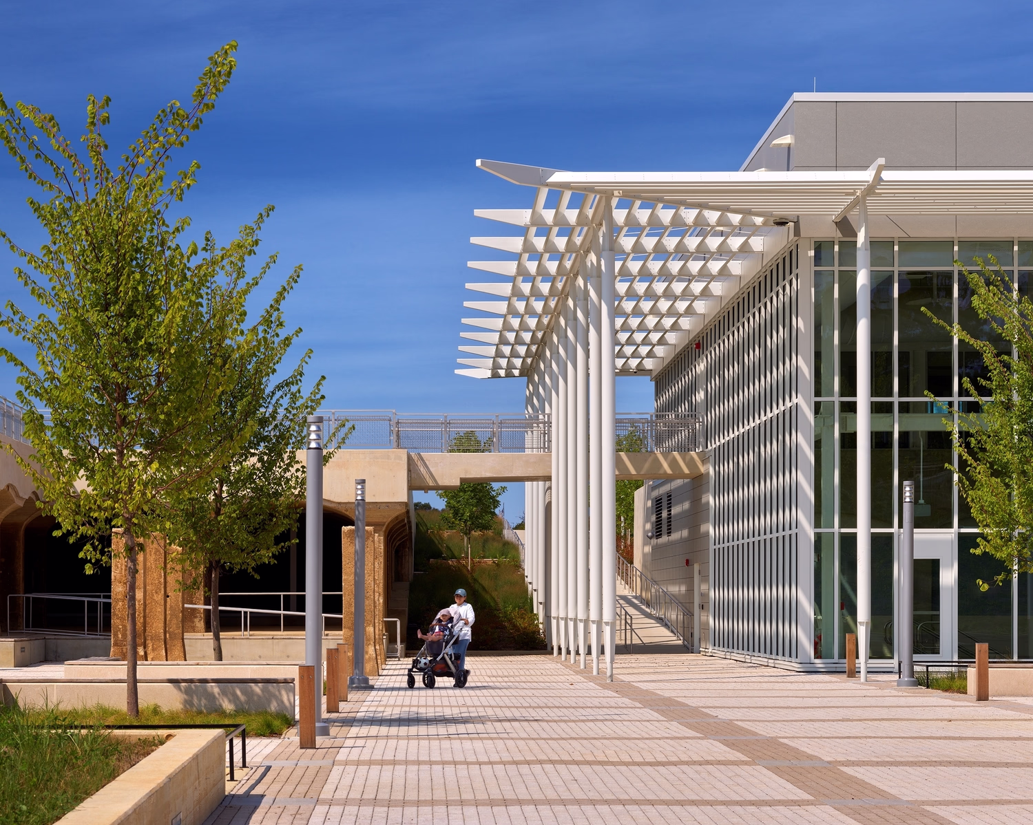 Visitors stroll on the outdoor plaza at Reservoir Park and Recreation Center.