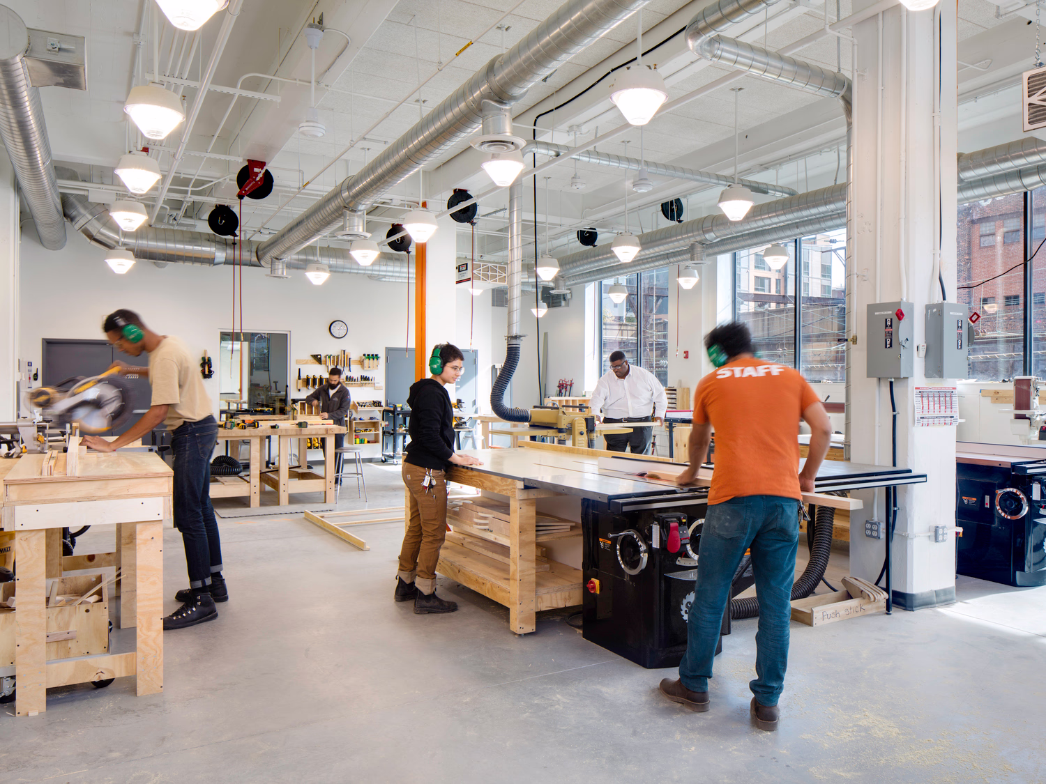 Workers use wood working tables.
