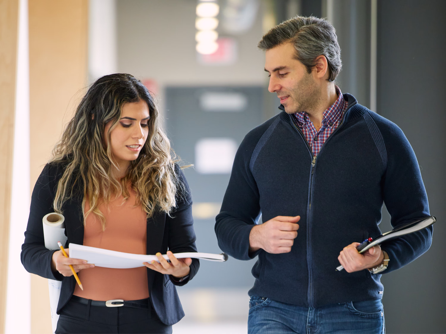 Two colleagues engage in conversation.