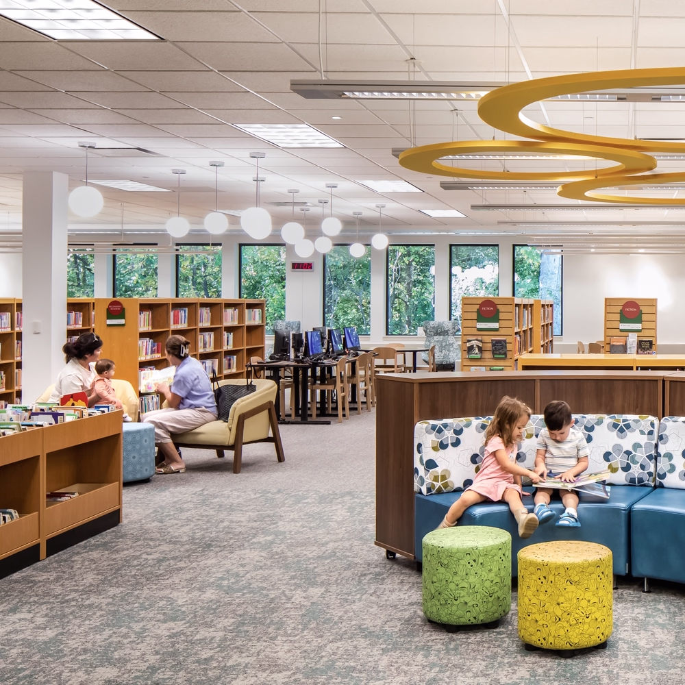 Children and families read in a library.