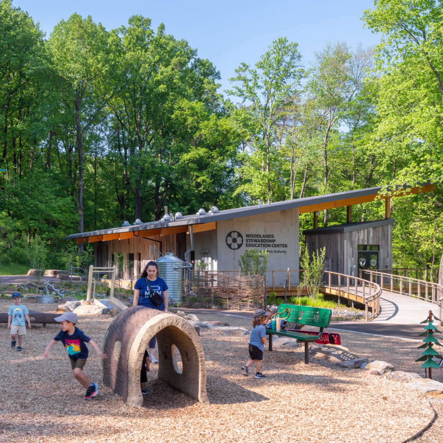 Children play in front of the Woodlands Stewardship Education Center.