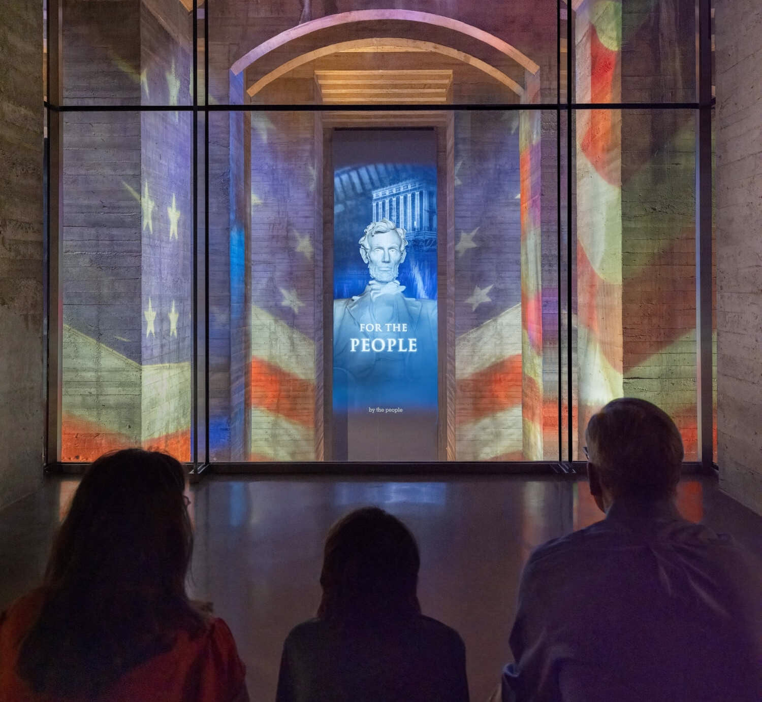 Visitors watch a video inside the Lincoln Memorial Museum.