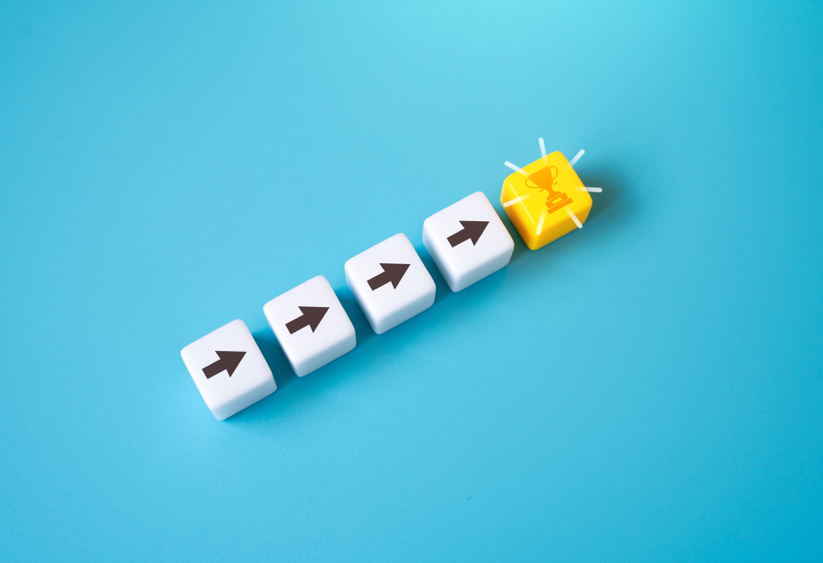 four arrows on white blocks leading to a yellow block with a trophy on it