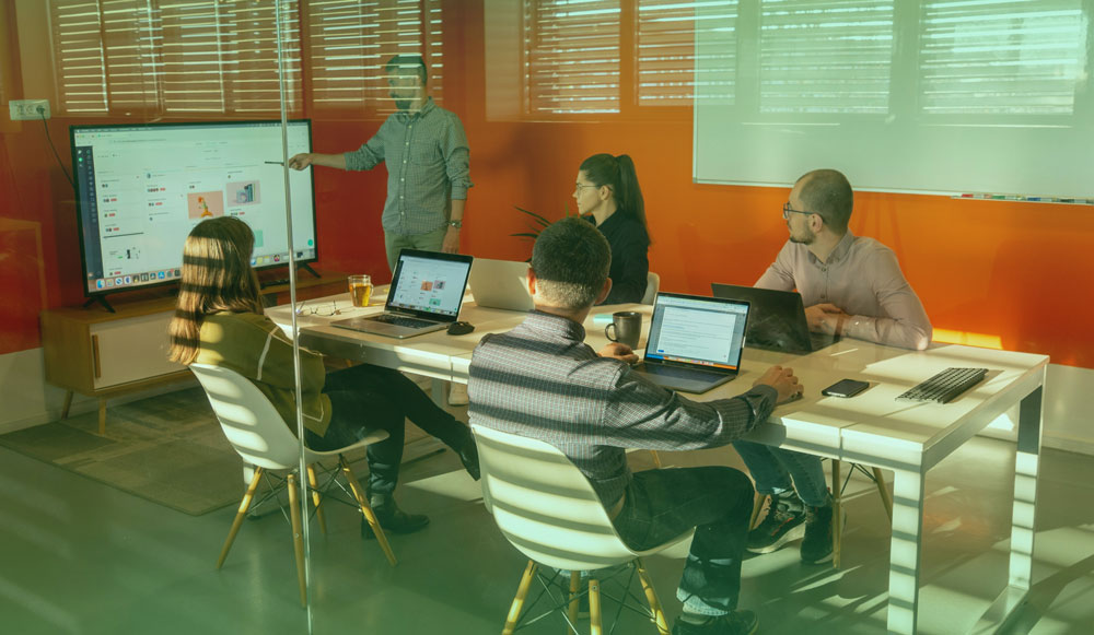 People looking at a screen together and discussing