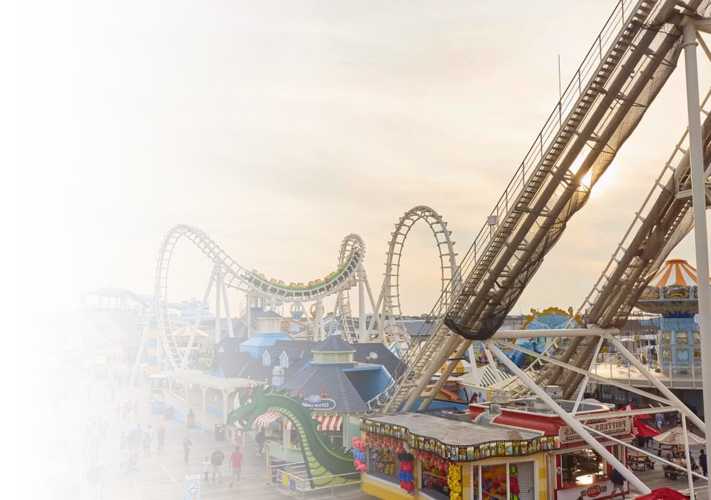 Families enjoying a busy theme park with roller coasters and seamless ticketing operations