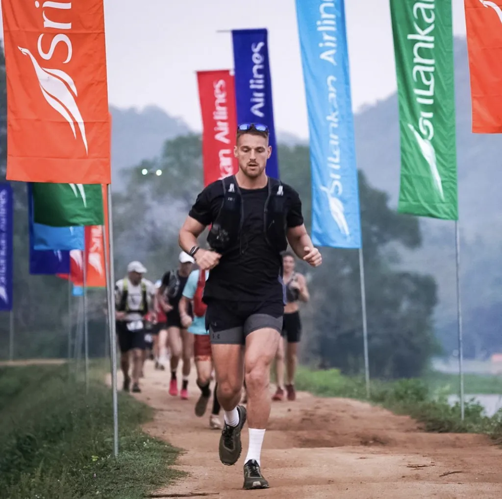Man in black outfit running.