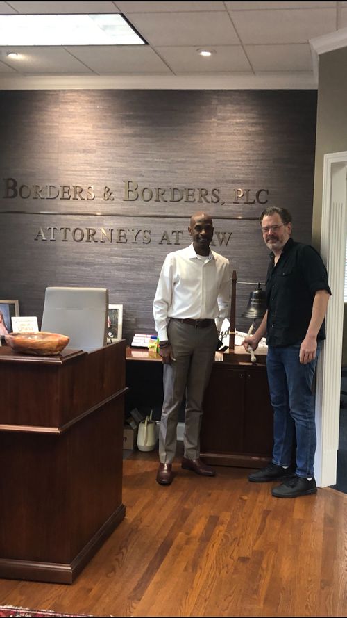 New homeowner holding a "We Bought a House!" sign