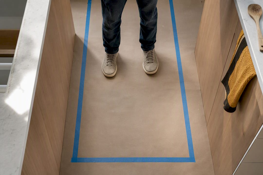 Painter tape marking a kitchen aisle