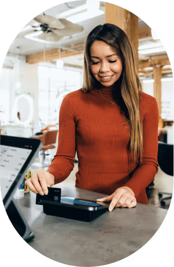 Woman swiping her credit card.