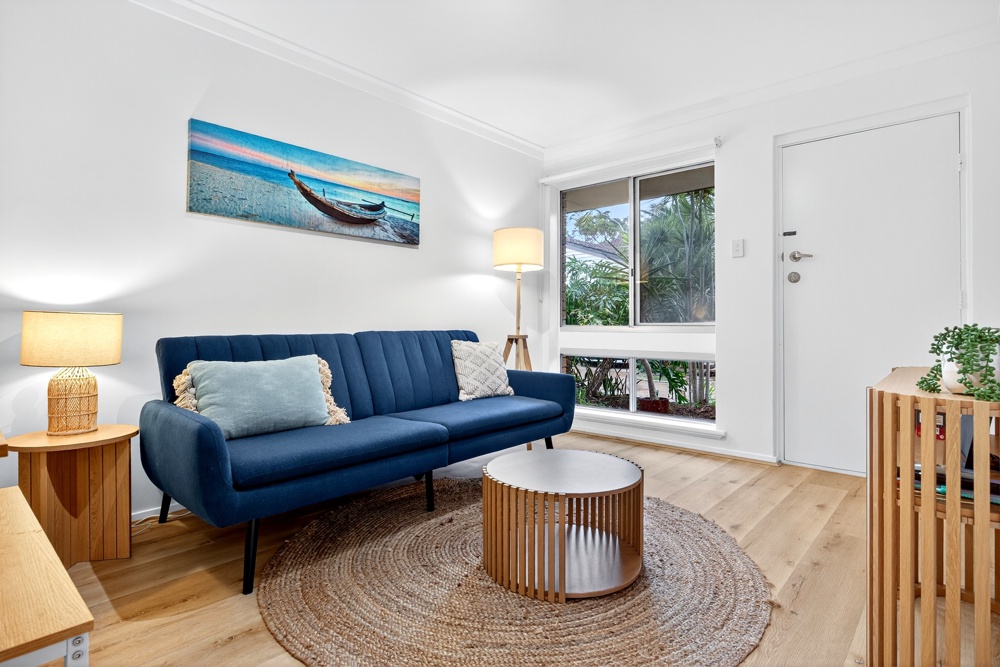 Bright living room with a blue sofa in a MadeComfy two-bedroom Scarborough apartment