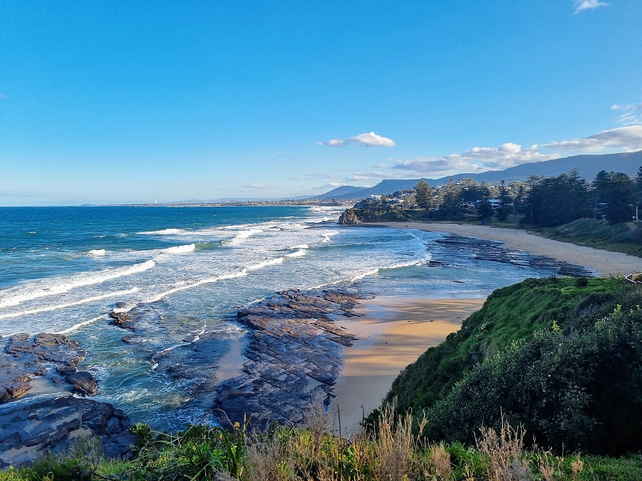 Little Austinmer Beach with its rocky headland and Norfolk Island pines
