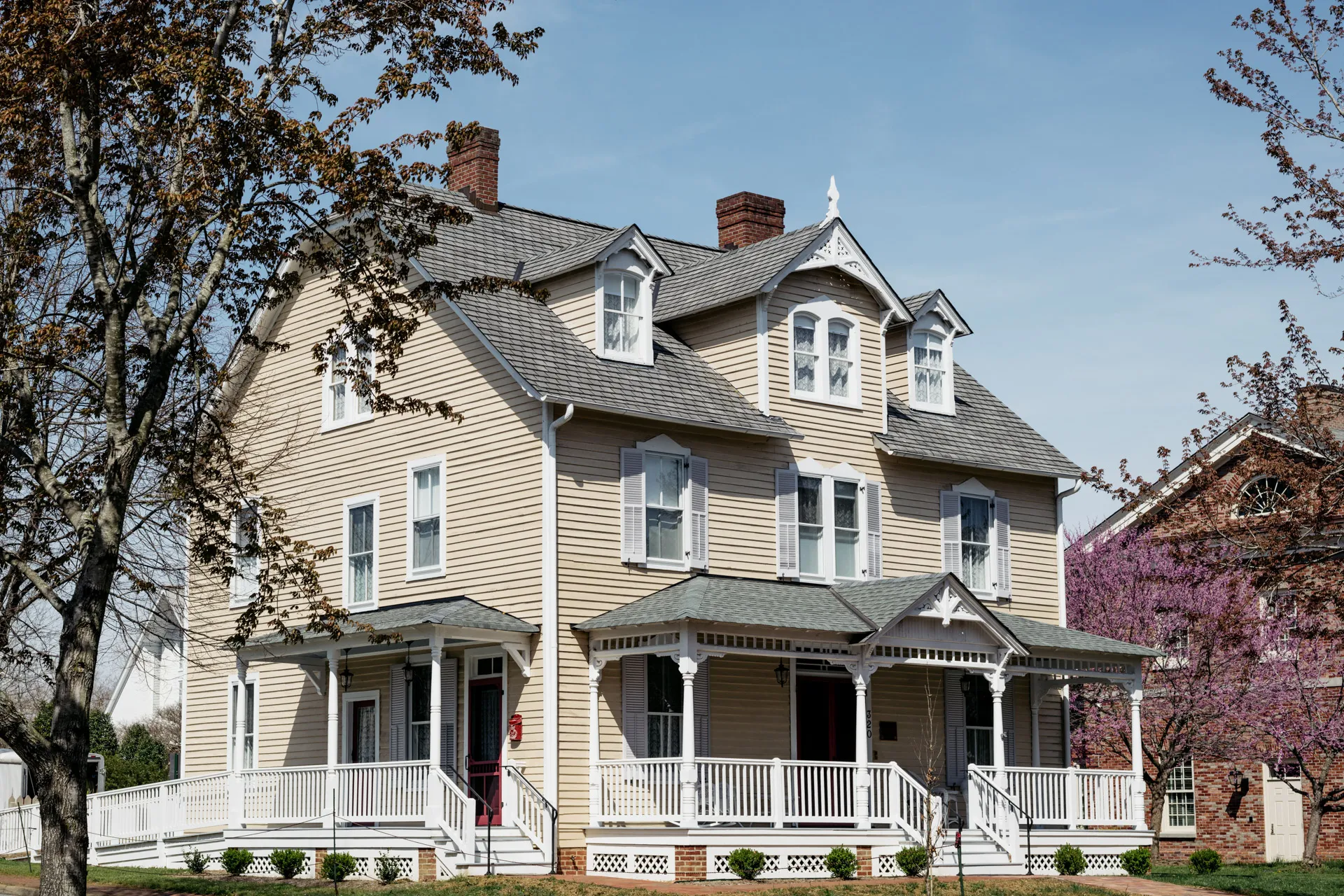 Armistead House exterior — restored 1890 Victorian inn with yellow clapboard siding and wraparound porch, two blocks from Colonial Williamsburg