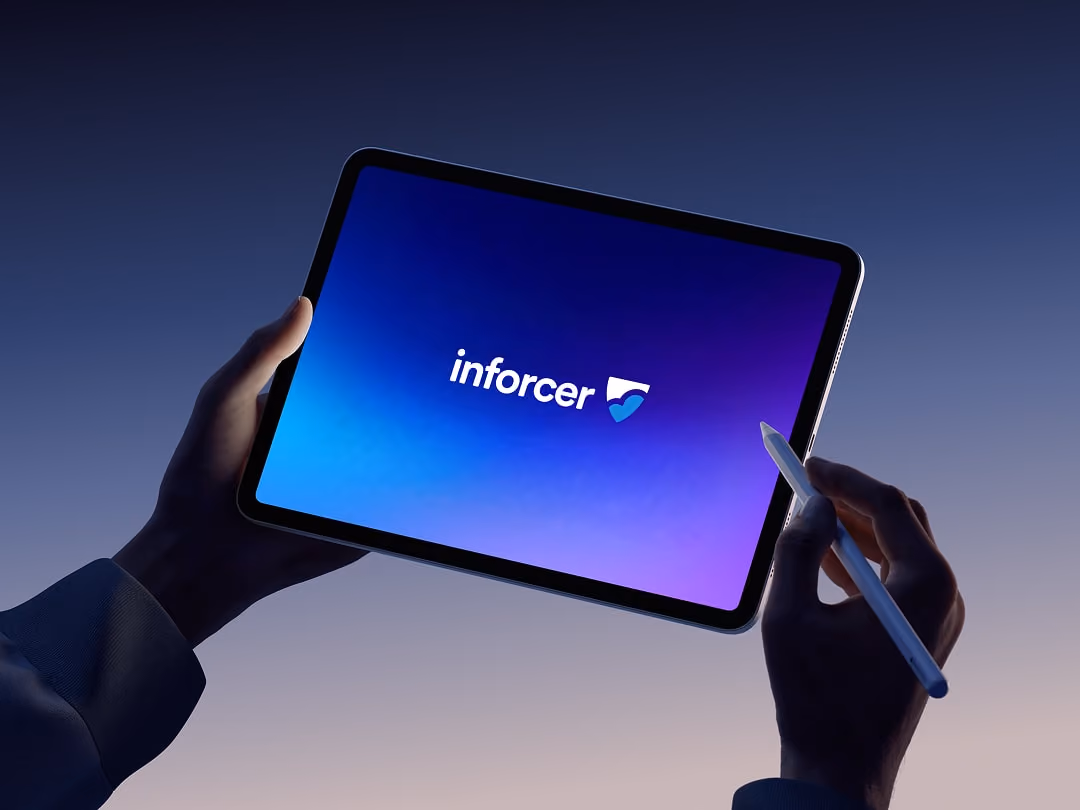 Hands holding a tablet displaying a blue-purple screen with the text 'inforcer' and a heart-shaped logo.