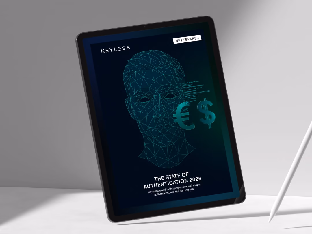 Tablet displaying a whitepaper titled 'The State of Authentication 2026' with a digital face wireframe.
