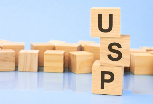 Wooden letters piled up that spell USP