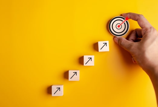 Arrows pointing up towards a target