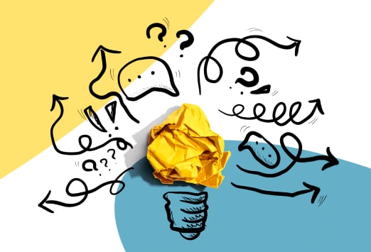 Scrunched up paper making a lightbulb symbol with arrows and shapes