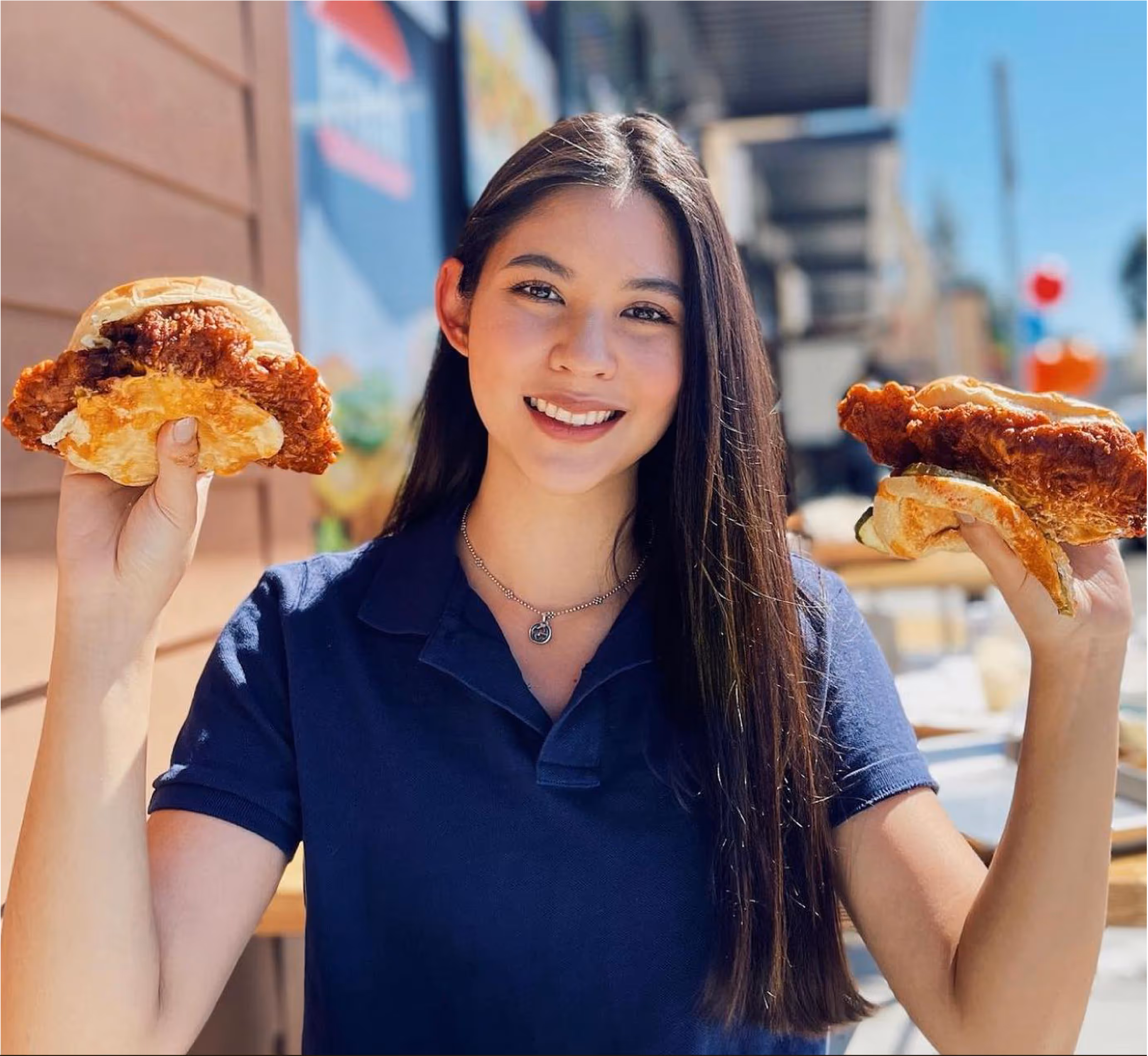 Girl from iniBurger holding Burgers and smiling