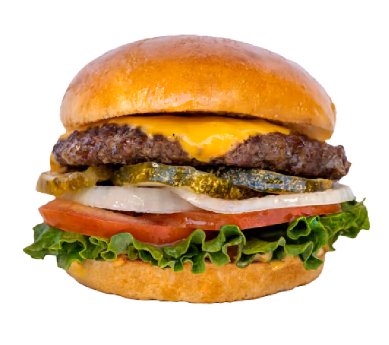 Cheeseburger with lettuce, tomato, sliced onion, pickles, melted cheddar cheese, and beef patty on a toasted bun.