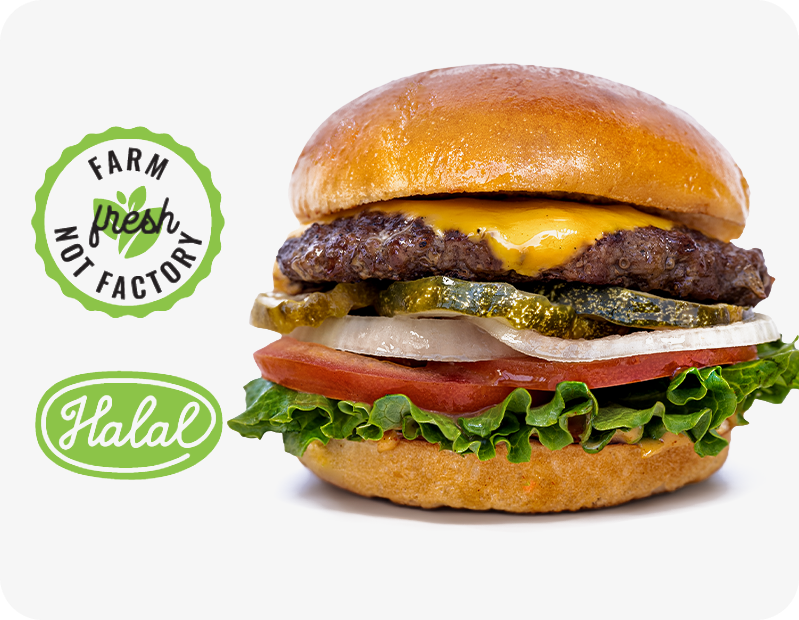 Cheeseburger with lettuce, tomato, onion, pickles, and melted cheddar cheese in a brioche bun, accompanied by 'Farm fresh not factory' and 'Halal' labels.