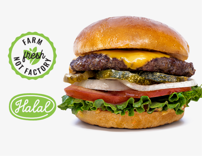 Cheeseburger with lettuce, tomato, onion, pickles, and melted cheddar cheese in a brioche bun, accompanied by 'Farm fresh not factory' and 'Halal' labels.