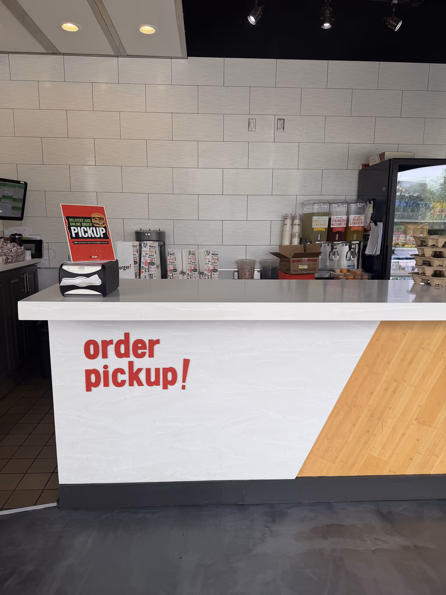 Two closed imBurger takeout boxes with white lids printed with various food-related icons and the red logo on a white surface.