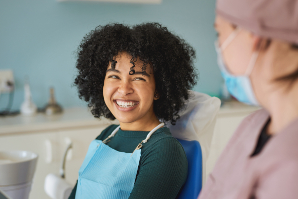 A woman smiling at her dentist 