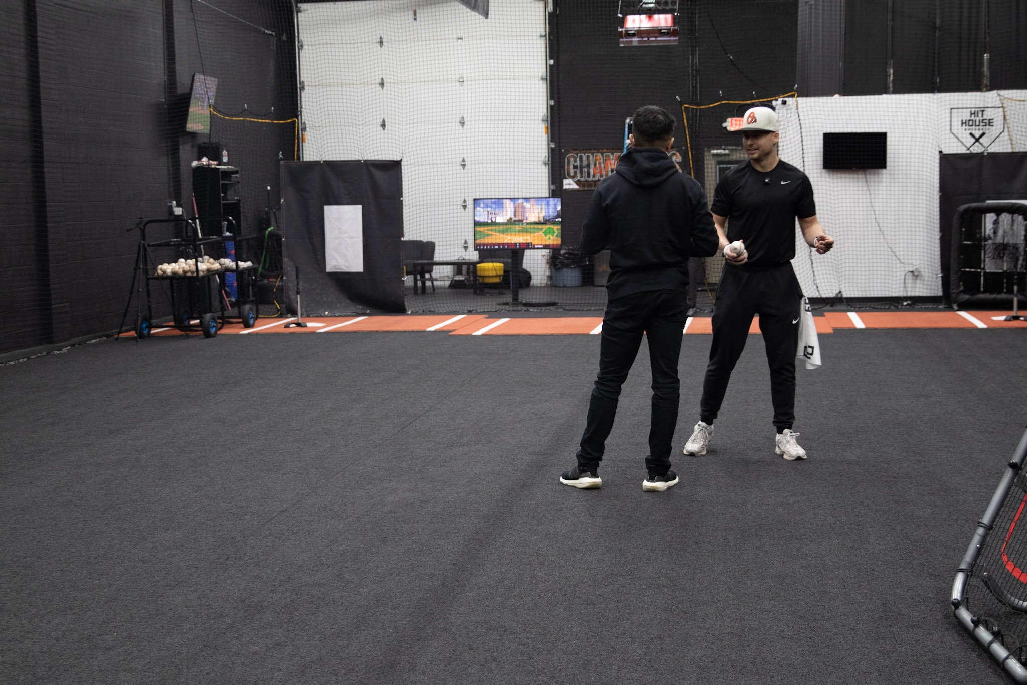 Coaches talking at Hit House Ohio baseball facility