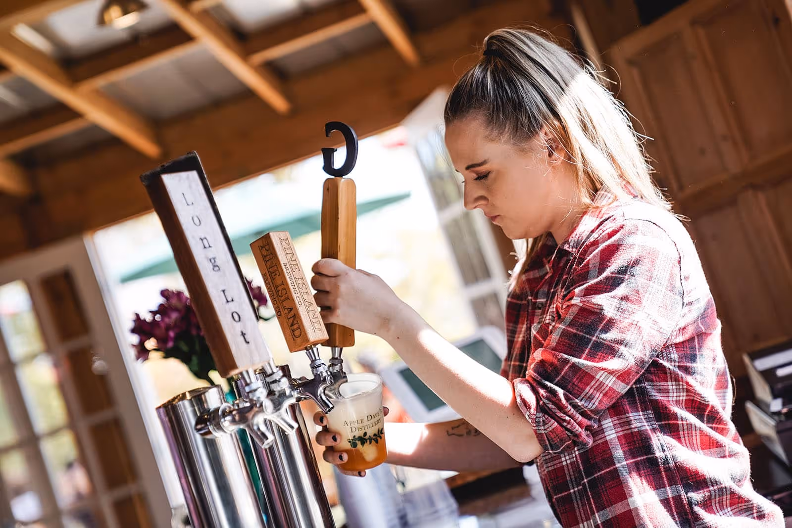 Bartender pouring craft beer from tap