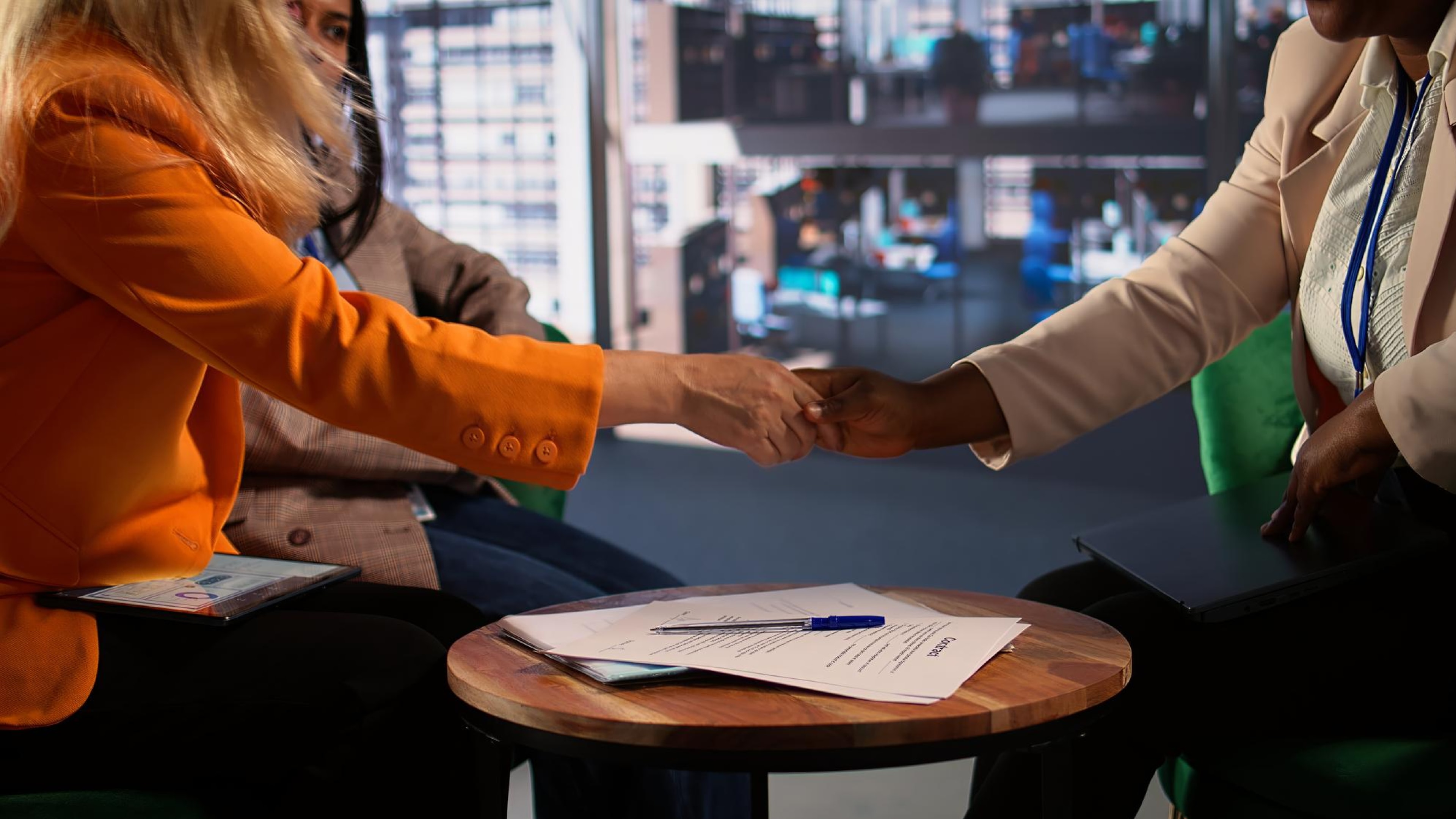 A manager of small businesses shaking hands with a Internet telephony service provider who can integrate SIP trunks with their existing phone system..