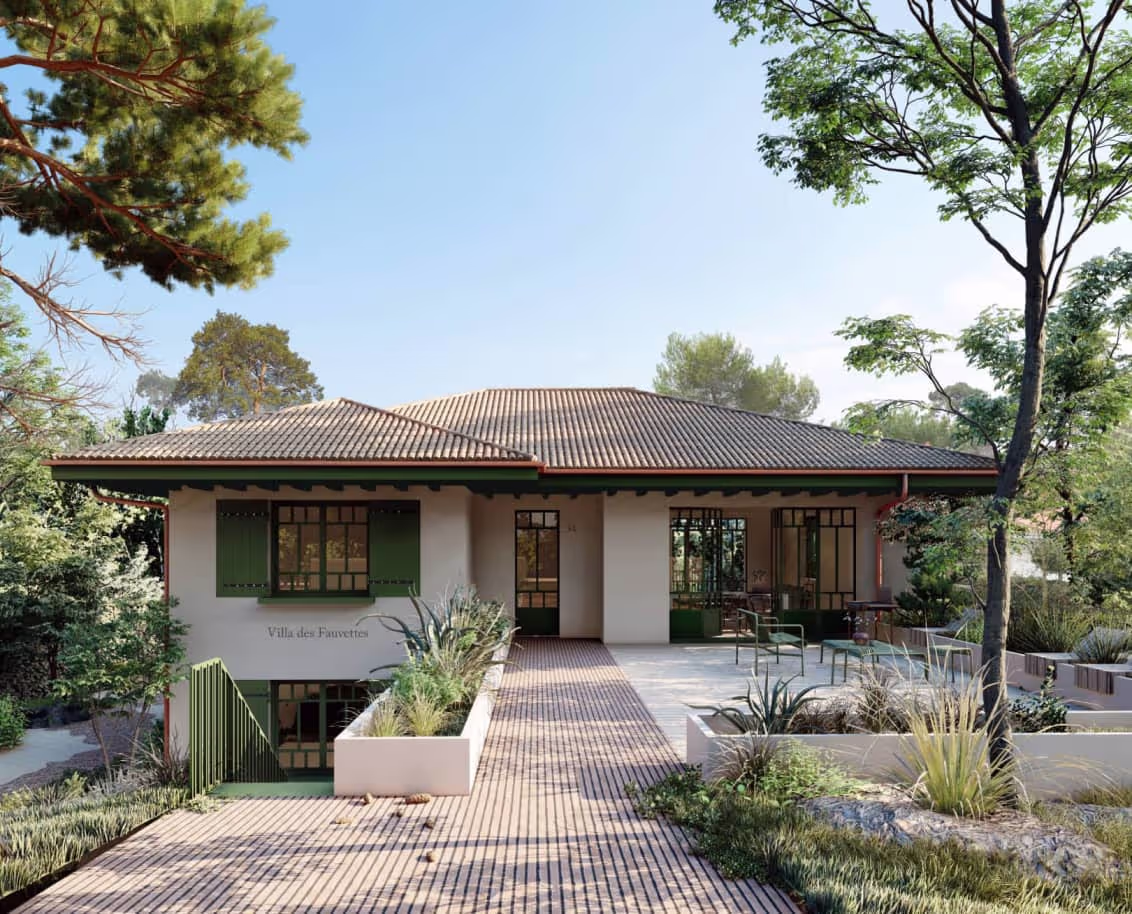 Maison avec menuiseries verte, grande terrasse en brique et jardinières maçonnées