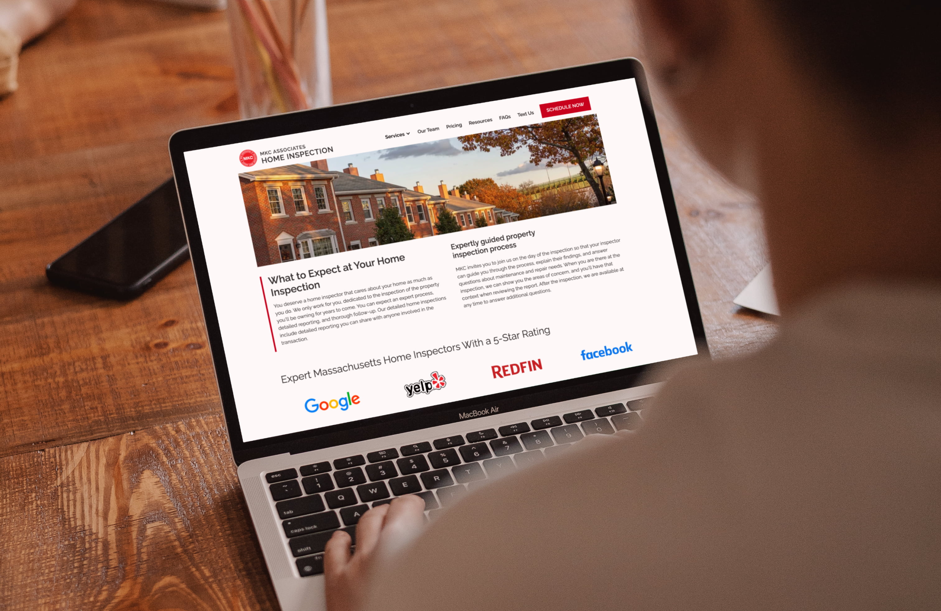 The MKC website in use, featuring the homepage "What to Expect" section viewed on a laptop.