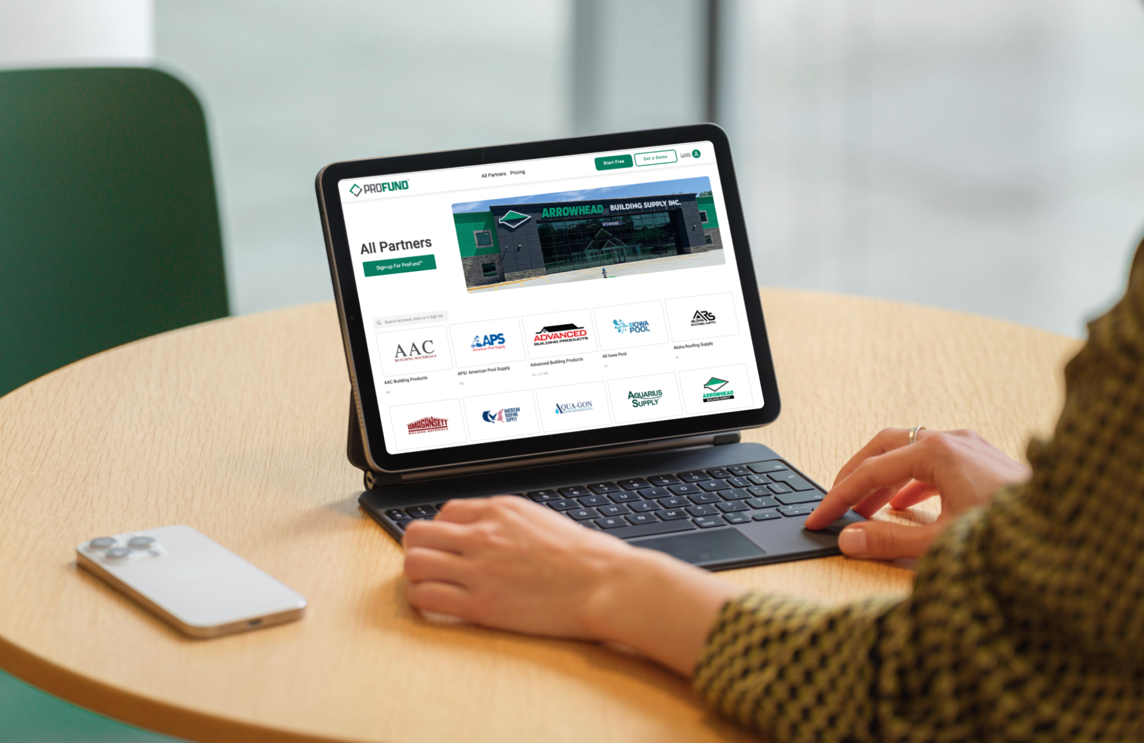 A person using a tablet to search the ProFund brand index on the All Partners page.