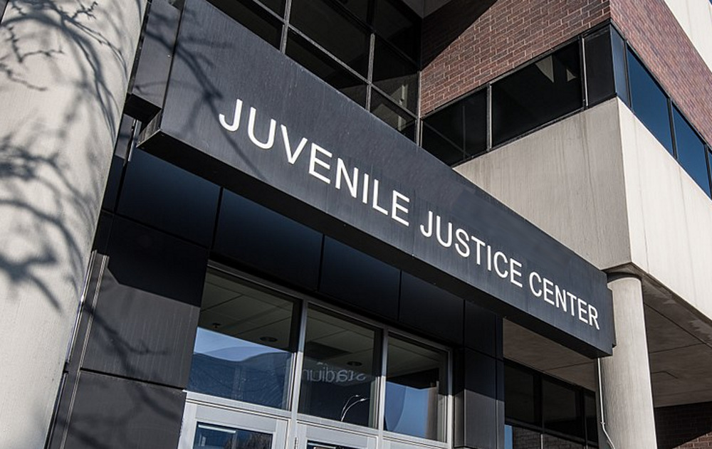 court-involved youth, juvenile justice: Juvenile Juctice Center modern red brick and cement building with black sign