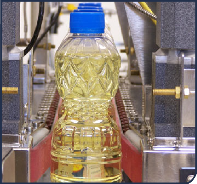 Industrial metal inspection machine with control panel on a stand and status light on top.