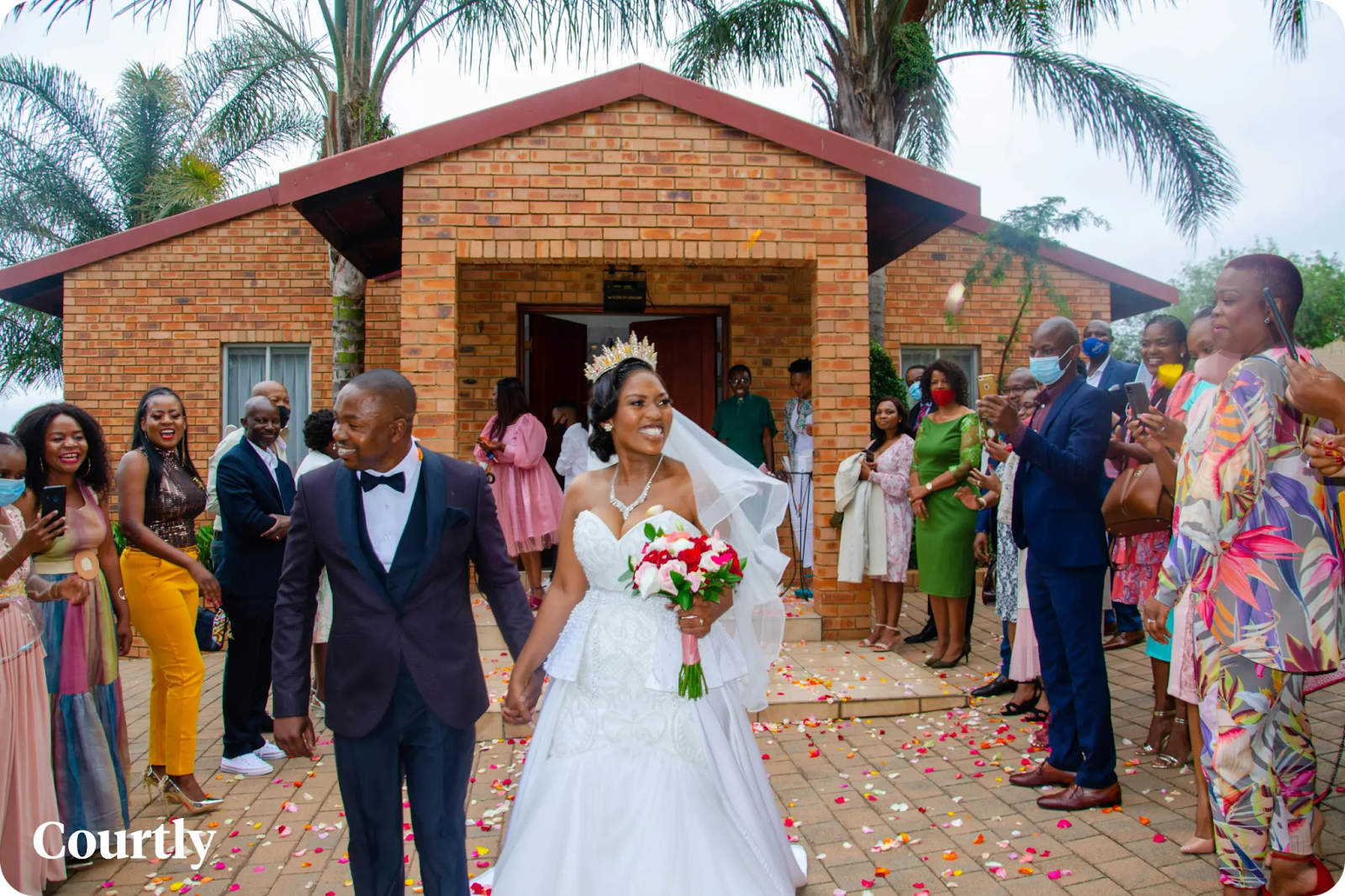 Bride and groom at Nigerian wedding ceremony with family and friends celebrating wedding traditions.