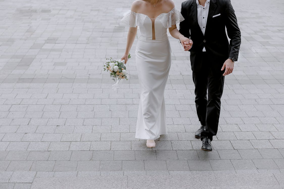 Newlywed couple walking together, starting the process of changing name after marriage.