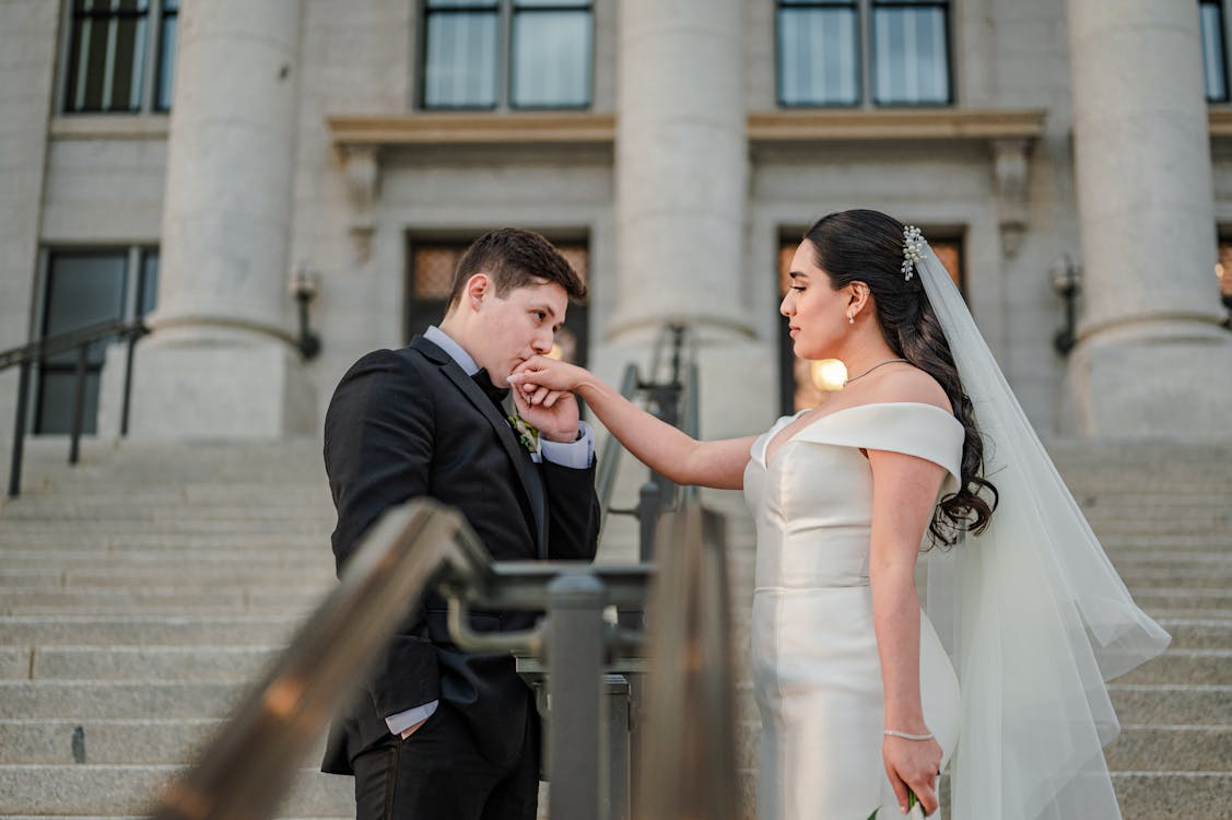 Bride and groom share a moment on courthouse steps after their marriage ceremony.