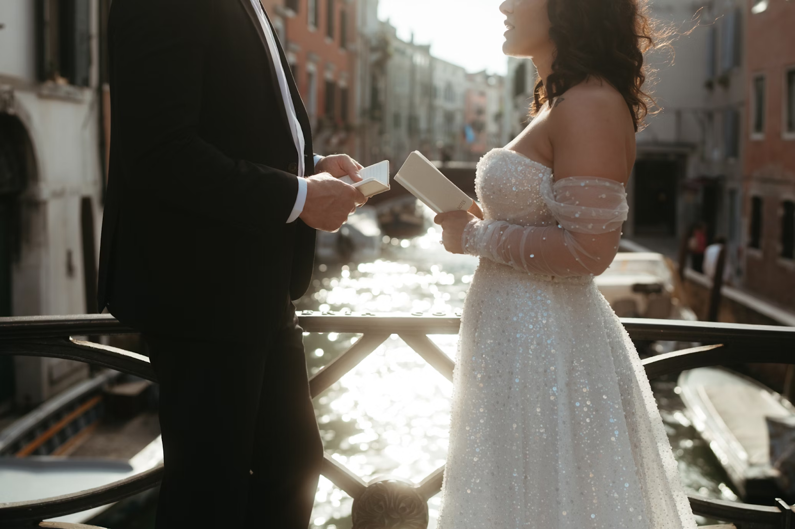 Couple exchanging vows with wedding vow generator free books during outdoor ceremony