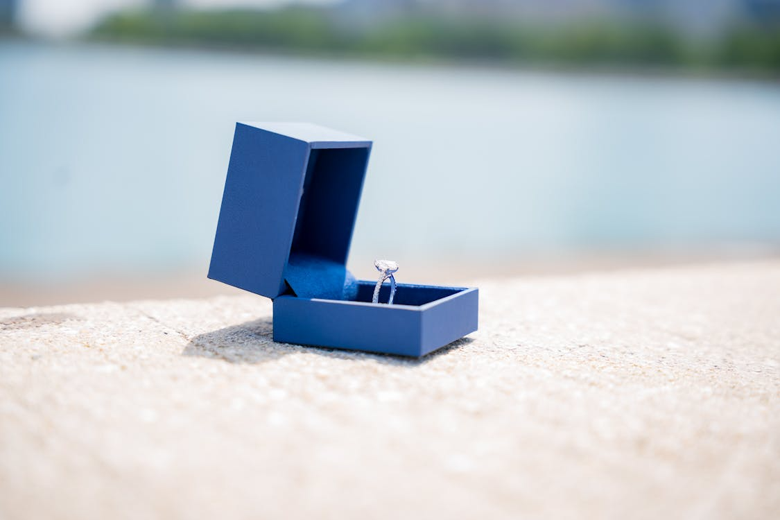 Elegant engagement ring in blue box symbolizing proxy marriage meaning and modern wedding alternatives