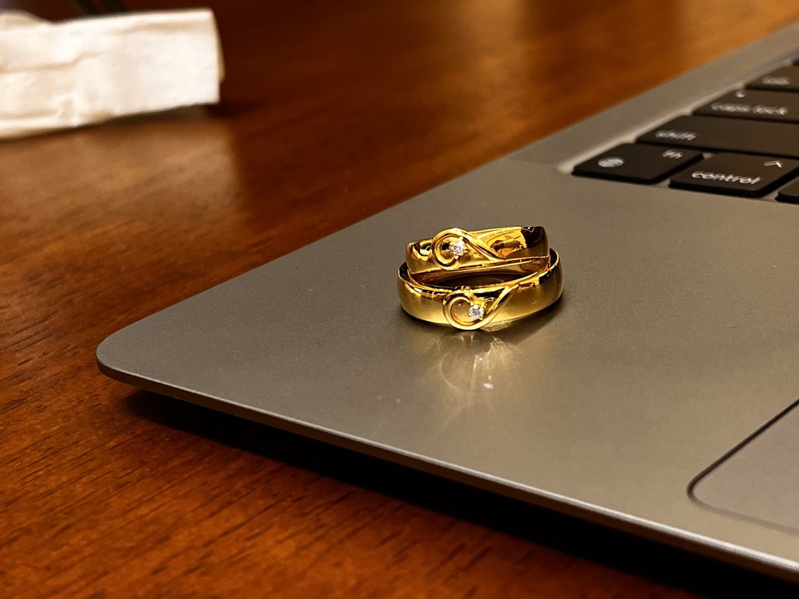 Gold wedding rings on laptop symbolizing safer online alternatives to proxy marriage