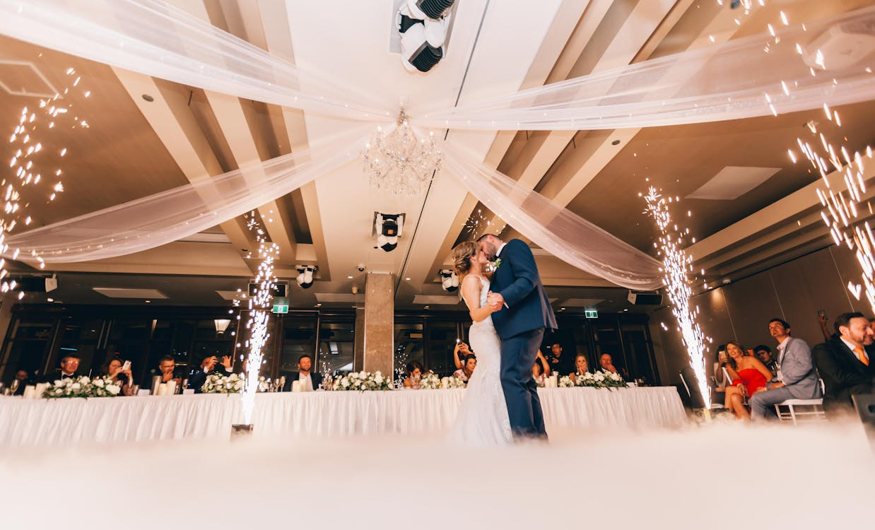 Newlyweds dancing with sparklers around them, a moment reflecting proper wedding etiquette at receptions