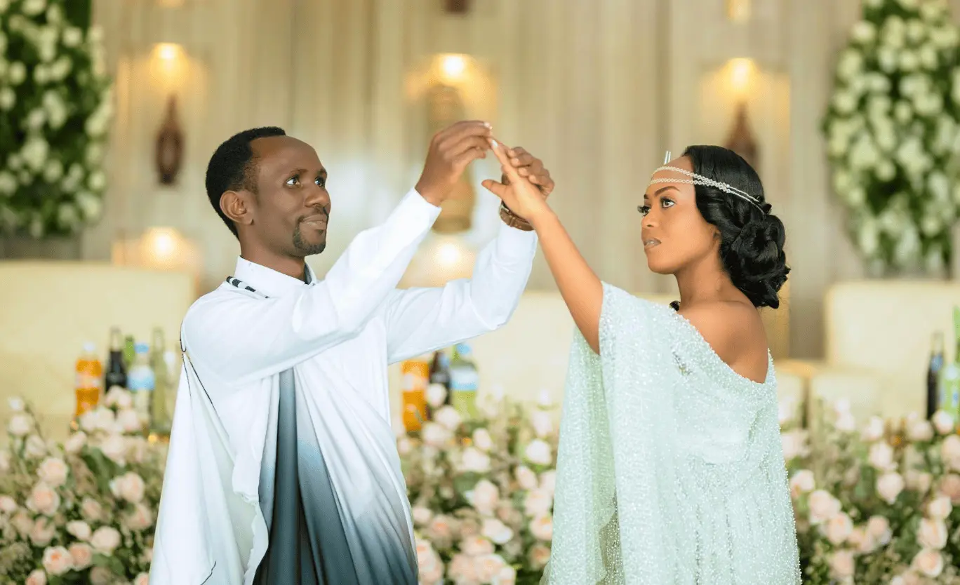 Elegant couple in traditional dress dancing at wedding: wedding night traditions.