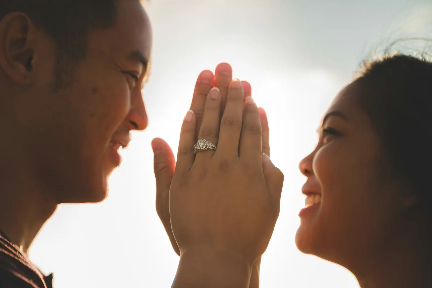 Husband and wife holding hands and smiling: legal benefits of marriage.