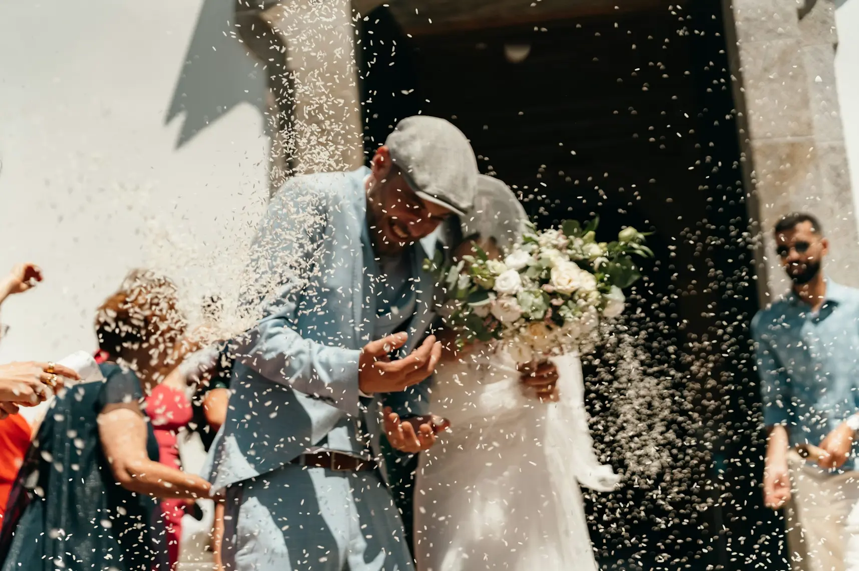 Newly married couple leaving church with rice thrown on them: biblical marriage vs legal marriage.