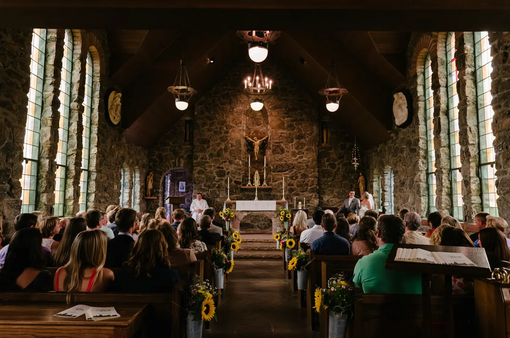 Guests waiting in church for wedding to begin.