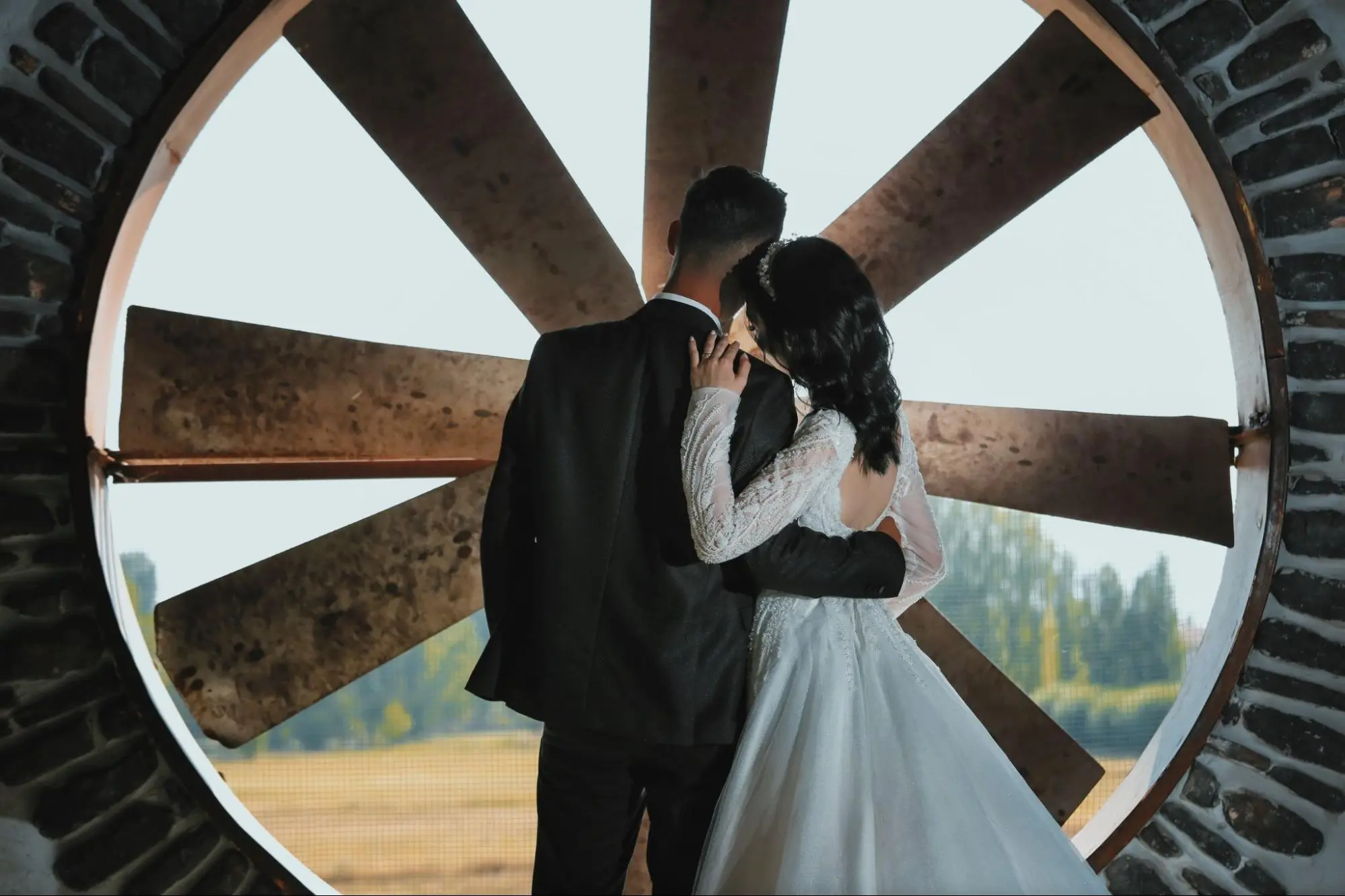 Interfaith couple from different cultural backgrounds standing together confidently outdoors