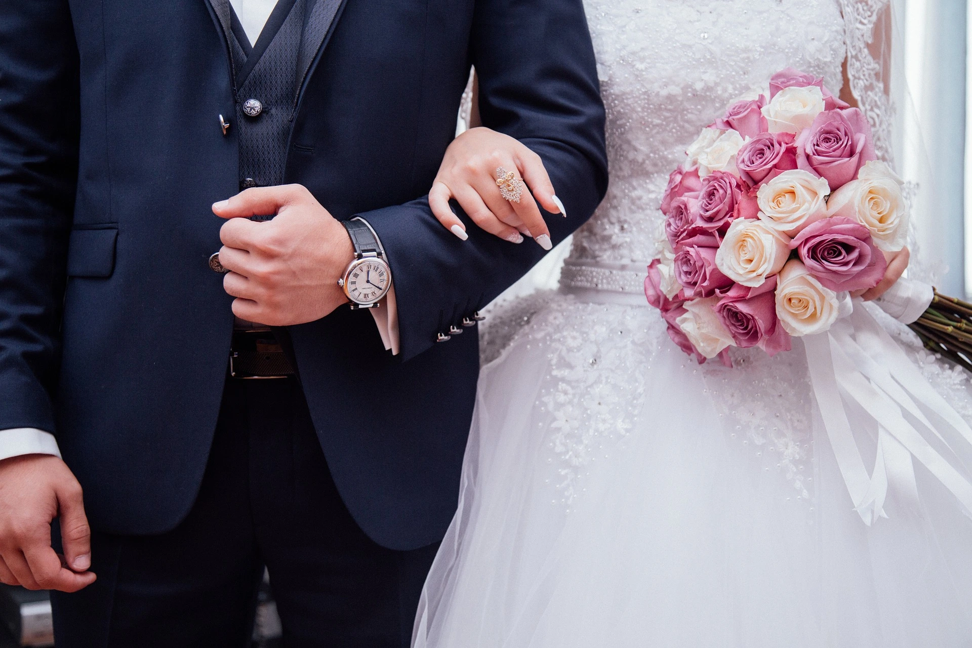 Newlywed couple holding hands, symbolizing proof of genuine marriage