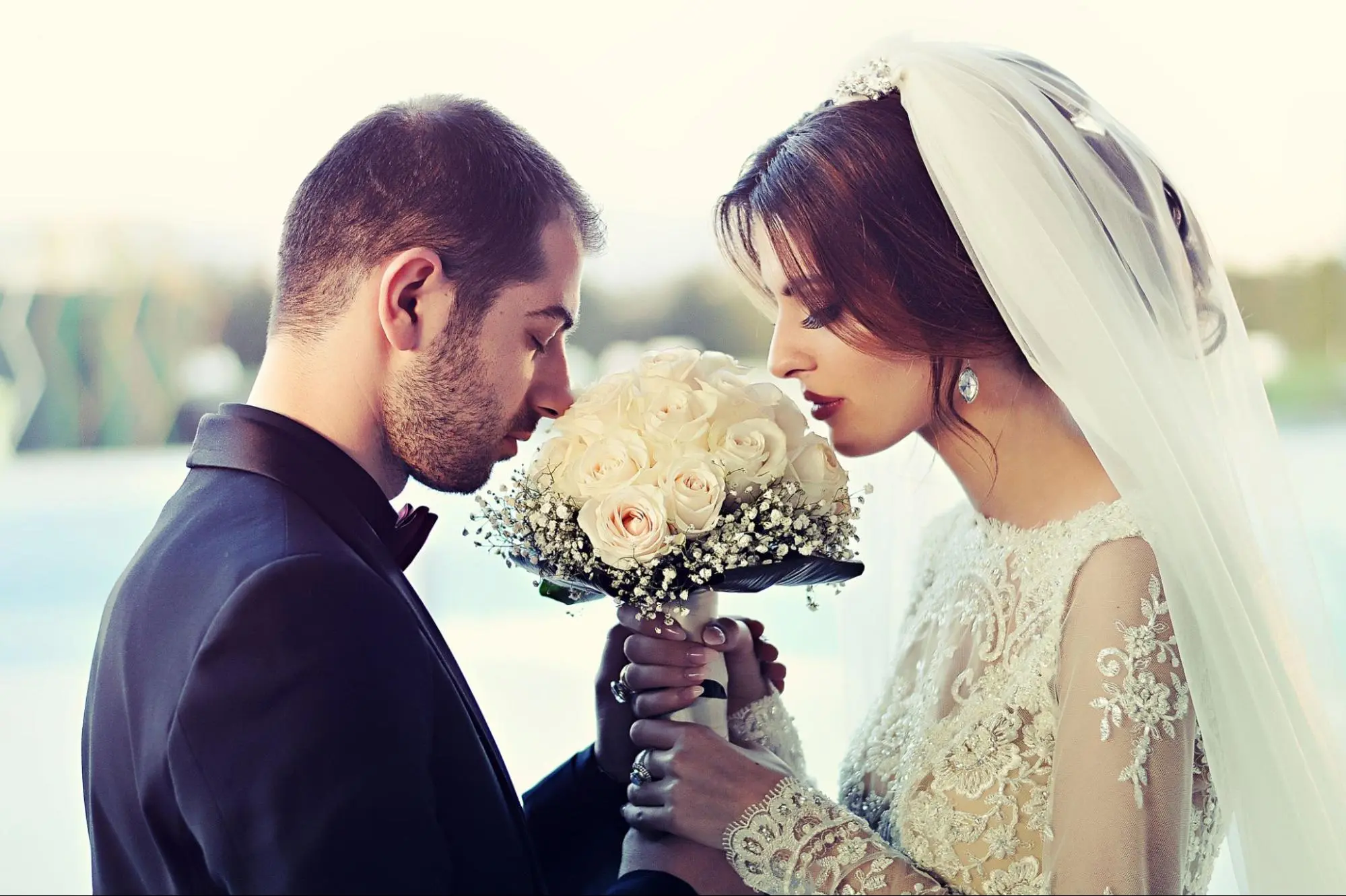 Bride and groom holding bouquet, representing genuine marriage proof.