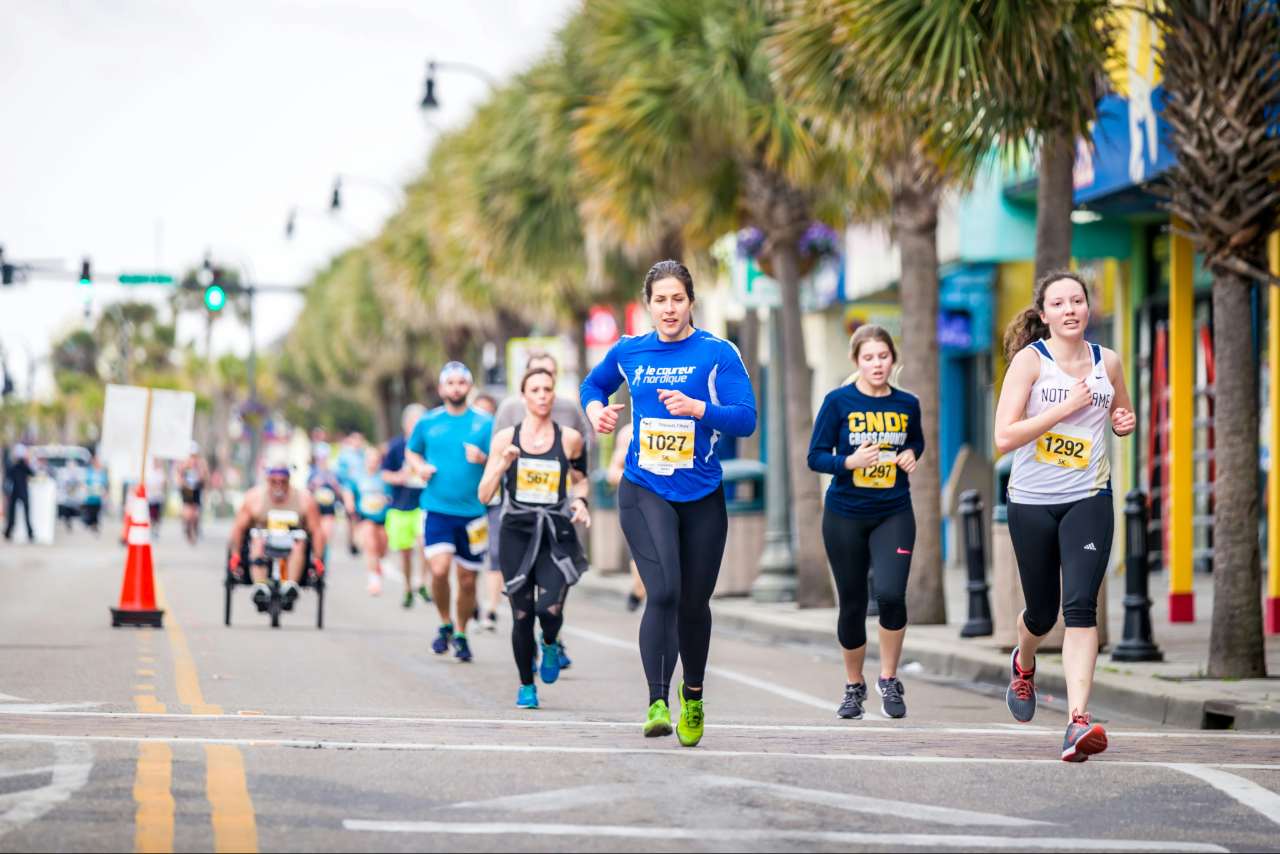 A group of people running a 5K race